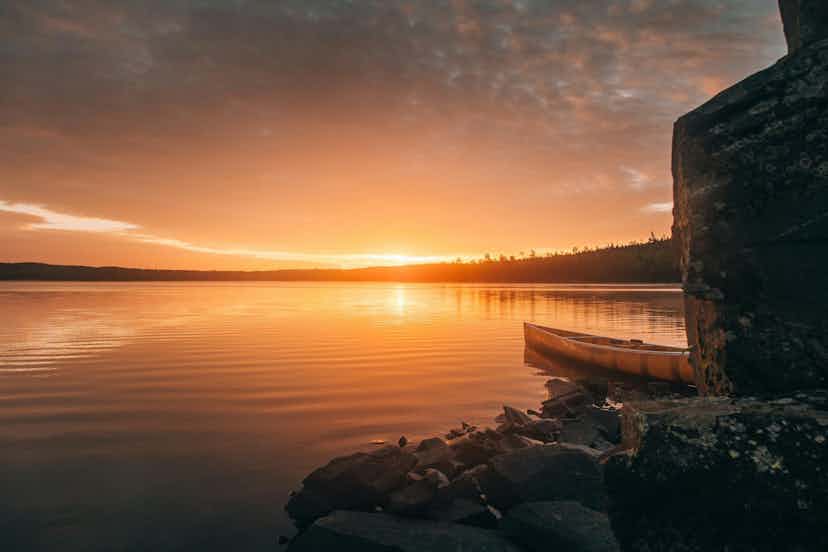 Minnesota lake at sunset with a canoe